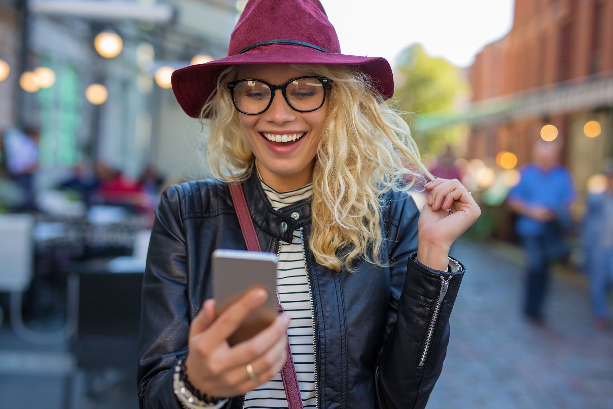 excited woman reading from her iPhone