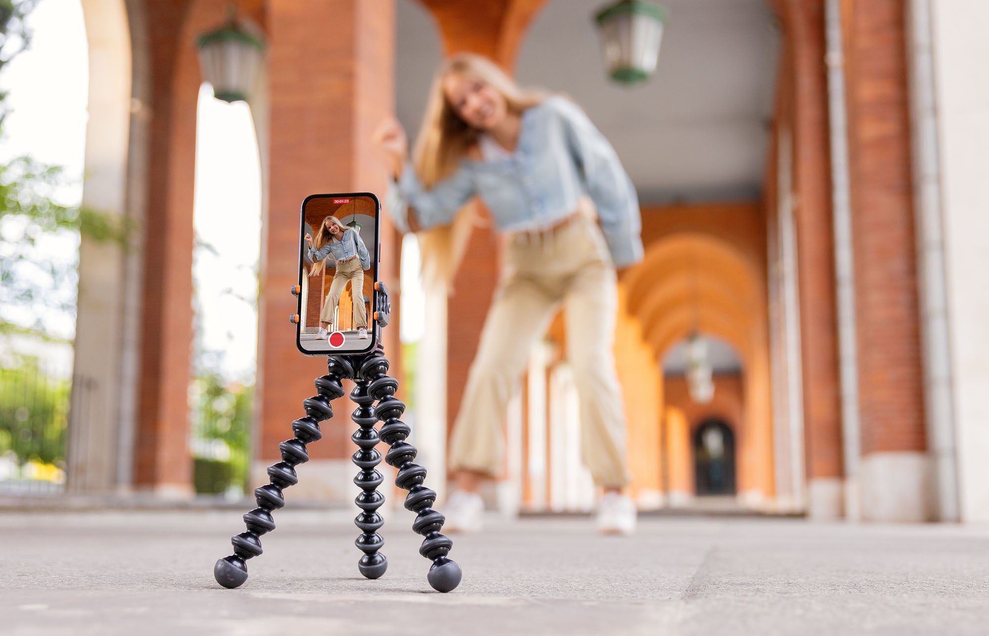 woman smiling taking a photo with her used iPhone