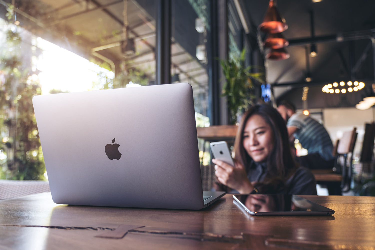 woman smiling using Apple products